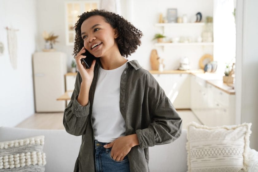 Biracial woman awswering a call and talking to a telemarketer on a mobile phone.